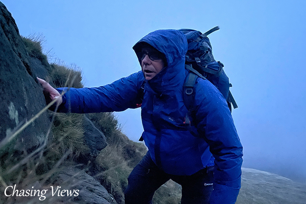 Ash Wroughton climbing Grindslow Knoll in bad weather